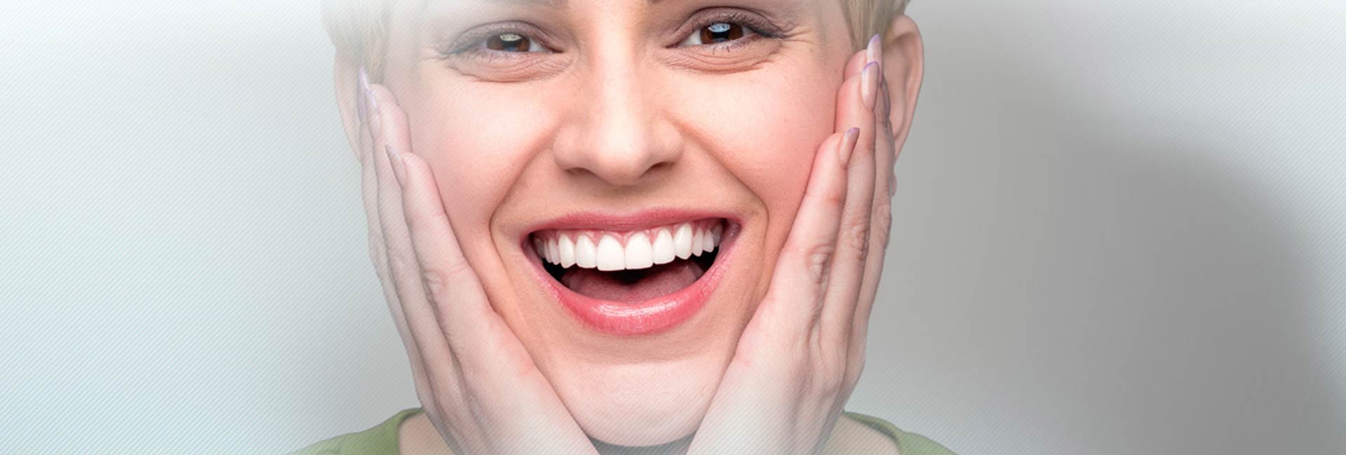 Woman smiling with both hands on her cheecks